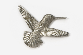 A silver hummingbird is flying in the air.