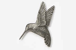 A metal hummingbird with wings spread and a beak open.