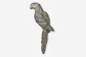 A silver parrot sitting on top of a white wall.