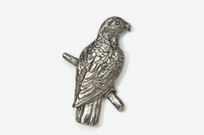 A silver bird sitting on top of a tree branch.