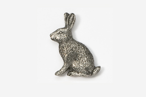 A silver rabbit sitting on top of a white table.