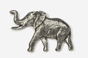 A silver elephant is standing up against the wall.