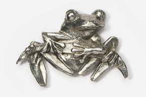 A silver frog sitting on top of a white surface.