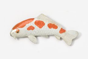 A fish is laying on the ground and has orange spots.