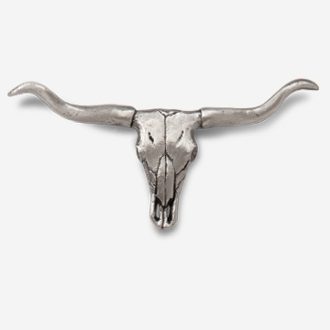 A silver steer head with horns on top of it.