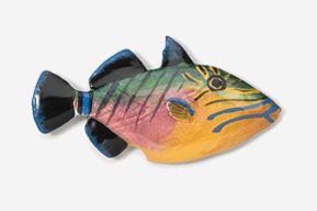 A fish is painted in different colors and designs.