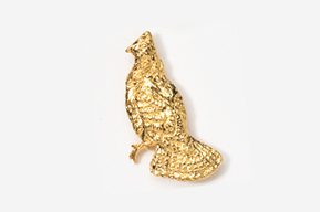 A gold bird sitting on top of a white surface.