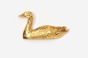 A gold duck sitting on top of a white surface.