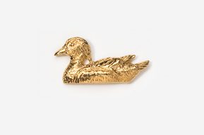 A gold duck sitting on top of the ground.