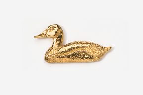 A gold duck sitting on top of the ground.