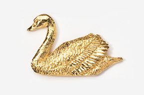 A gold swan sitting on top of a white surface.