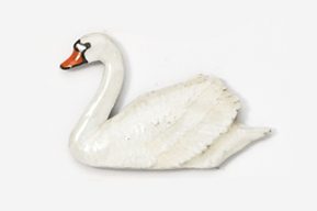 A white swan with orange beak and tail.
