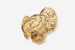 A gold turkey brooch is shown in this image.