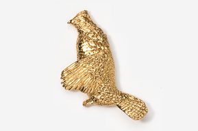 A gold bird is flying in the air.