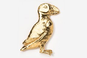 A gold bird sitting on top of a white table.