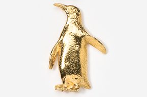 A gold penguin is standing on the ground.