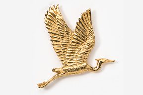 A gold bird flying in the air with its wings spread.