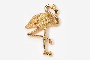 A gold flamingo is standing on one leg.