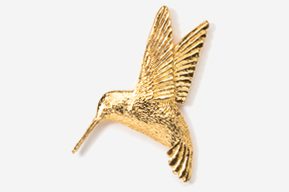 A gold hummingbird is flying in the air.