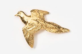 A gold bird is flying in the air.