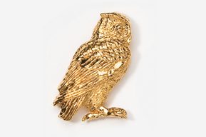 A gold owl sitting on the ground.