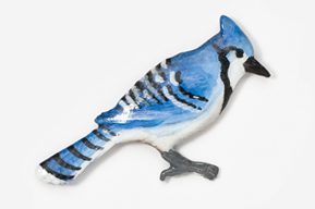 A blue jay bird is painted on the side of a wall.