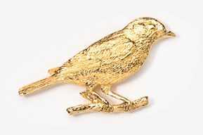 A gold bird sitting on top of a branch.