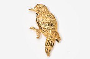 A gold bird sitting on top of a white table.