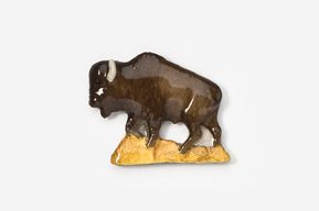 A ceramic bison figurine is shown on top of a white background.