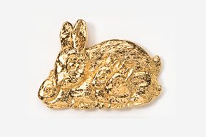 A gold rabbit sitting on top of a white table.