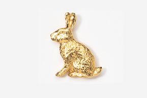 A gold rabbit sitting on top of a white table.