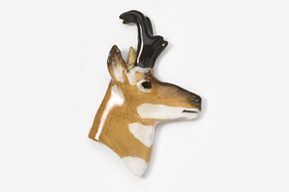 A ceramic antelope head with horns on it's back.