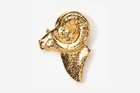 A gold ram head pin with a leaf on it's face.