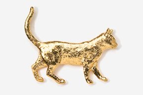 A gold cat is walking across the floor.