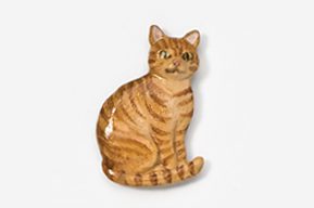 A cat sitting on top of a white table.