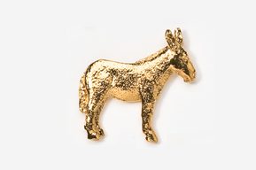 A gold colored donkey is standing next to the wall.