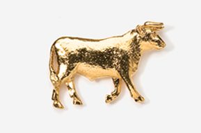 A gold cow is standing in front of the camera.