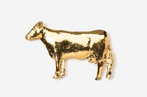 A gold cow is standing in front of the camera.