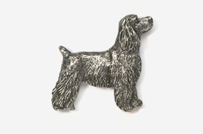 A silver dog is standing up against the wall.