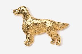 A gold dog is standing up against the wall.