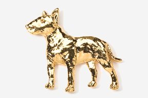 A gold colored dog is standing up against the wall.