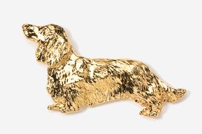 A gold dog is standing up against the wall.