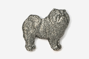 A silver dog is standing up against the wall.