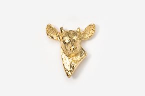 A gold cow head brooch is shown on a white background.