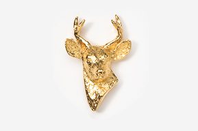 A gold deer head with antlers on top of it.