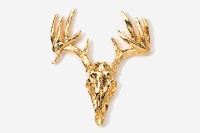 A gold deer head with antlers on top of it.