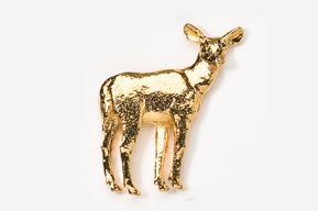 A gold deer is standing on the ground.