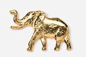 A gold elephant is standing in the middle of a wall.