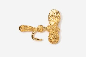 A gold plated piece of jewelry with a fish hook.