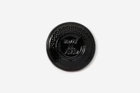 A black button with the words " made in japan ".